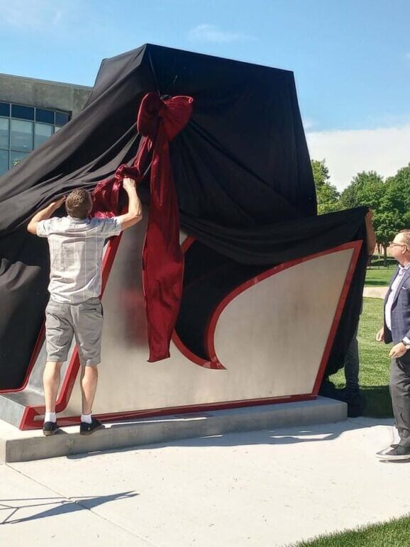 The big 'L' sculpture is unveiled at UW-La Crosse during a ceremony on June 23, 2026 (PHOTO: Brad Williams).